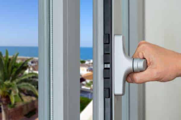 Close-up of aluminium window with secure locking system and reinforced frame for safety.